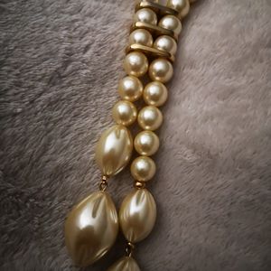 Long gold tone necklace with faux pearls